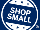 A blue circular badge with white text reading Shop Small in the center, surrounded by stars and a registered trademark symbol.
