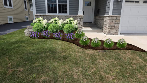 A landscaped flower bed with green shrubs, white flowers, and purple flowers borders the walkway of a gray house with stone accents and a white door.