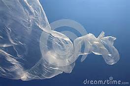 A transparent plastic bag floats underwater against a deep blue background, resembling a jellyfish.
